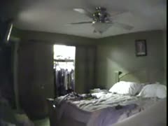 A lustful wife masturbates while remaining by herself on video while being concealed by a voyeur.
